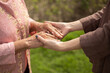 © chompoo - Hand of eldery woman with her caregiver at home. Home care or Elderly care concept.