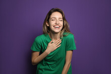 Cheerful Young Woman Laughing On Violet Background