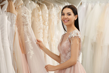 Canvas Print - Young woman choosing wedding dress in salon