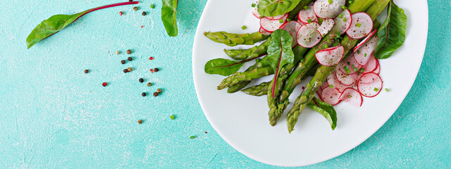 Salad from asparagus with radish and chard. Vegan cuisine. Healthy food. Flat lay. Top view