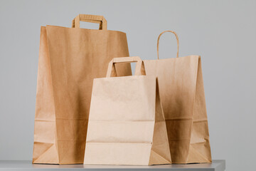 Wall Mural - Brown paper bag with handles, empty shopping bag with area for your logo or design, food delivery concept.