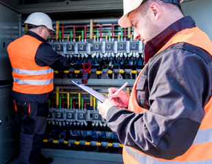Wall Mural - checking the operating voltage levels of the solar panel switchgear compartment