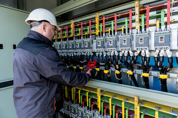 Wall Mural - Checking the operating voltage levels of the solar panel switchgear compartment