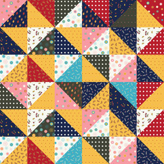 Seamless pattern of a patchwork quilt made from pieces of fabric with different patterns. Floral ornament, polka dots, autumn colors.