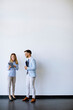 © BGStock72 - Young business people with tablet by the wall in the office