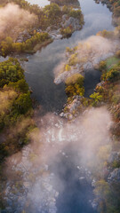 Wall Mural - amazing aerial view of foggy morning river and colorful trees. drone shot