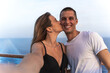© NDStock - young couple taking a selfie from a cruise ship during sailing