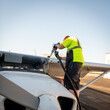 © knowlesgallery - Airport employee fills a small airplane with fuel