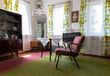 © valiantsin - Retro interior with furniture of 50s and 60s. Inside rural house with armchair, turntable and windows.