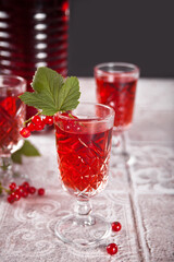 glasses of red currant brandy liqueur with ripe berries