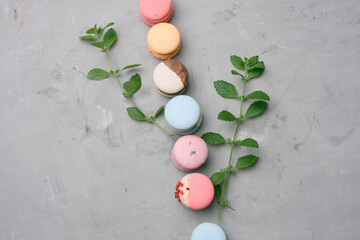 Wall Mural - baked macarons with different flavors on a gray cement background