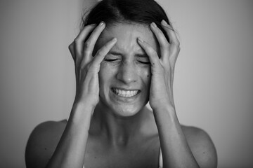 Closeup pose of an angry woman. Angry face. Depression. Stress. Photo. Background. 
