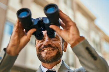 Sticker - Middle age businessman looking for new opportunity using binoculars at the city.