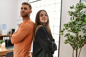 Wall Mural - Two caucasian business executives with arms crossed gesture standing at the office.