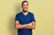 © Krakenimages.com - Young african american man with arms crossed gesture sticking tongue out happy with funny expression.