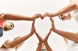 © Krakenimages.com - Group of young friends with hands together doing heart symbol.