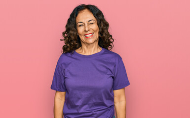 Poster - Middle age hispanic woman wearing casual clothes winking looking at the camera with sexy expression, cheerful and happy face.