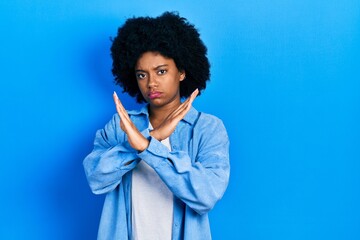 Wall Mural - Young african american woman wearing casual clothes rejection expression crossing arms doing negative sign, angry face