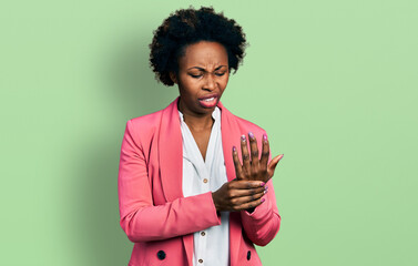 Sticker - African american woman with afro hair wearing business jacket suffering pain on hands and fingers, arthritis inflammation