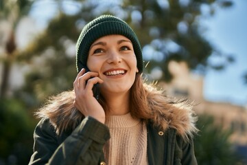 Canvas Print - Young caucasian girl smiling happy talking on the smartphone at the city.