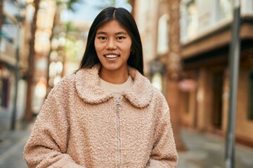 Sticker - Young asian woman smiling happy standing at the city.