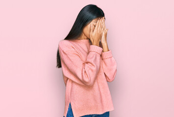 Sticker - Beautiful young asian woman wearing casual winter sweater with sad expression covering face with hands while crying. depression concept.