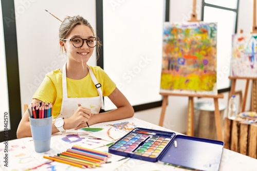 Young brunette teenager at art studio with a happy and cool smile on face. lucky person.