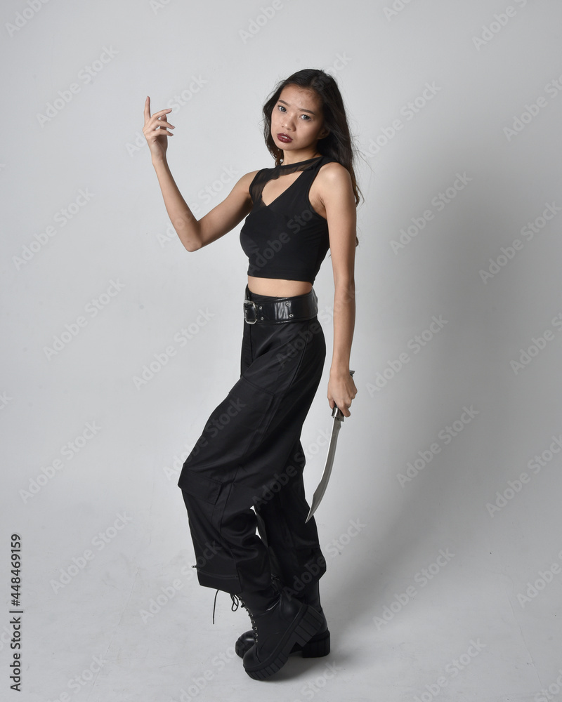 Full length portrait of pretty young asian girl wearing black tank top ...