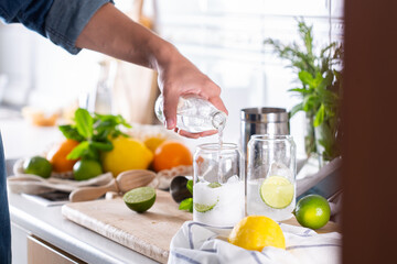 Wall Mural - Mixologist making refreshing cocktail with hard seltzer at home