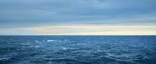 Panoramic View Of The Open Sea After The Storm At Sunrise. Dramatic Sky With Glowing Clouds. Epic Cloudscape. Fickle Weather, Ecology, Climate Change, Seasons