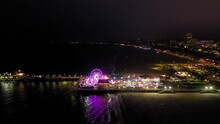 Flying Towards And Over The Ferris Wheel And Roller Coaster At The Santa Monica Pier Near Los Angeles California.