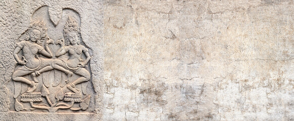 Wall Mural - Horizontal background with ancient wall carving with two womans - dancers apsara