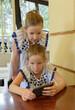 Two tween caucasian girls 9 years with a smartphone