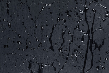 Water on dark stone surface