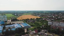 Wheat Field Near City Suburb, Local Farming Concept In Europe. Locally Grown Food. Sustainable Agriculture. Aerial View Of Village Life. Drone Point Of View