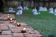 Oil lamps sparked by dharma practitioners.
