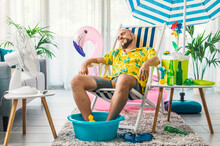 Man Having A Staycation And Resting On A Deckchair At Home