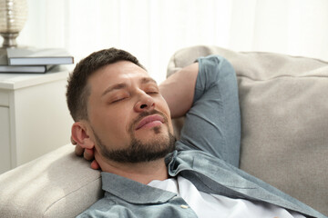 Canvas Print - Handsome man sleeping on sofa at home