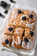 Wall Mural - Halloween decorated food. Banana bread cake bars with halloween marshmallow web and funny blackberry spiders