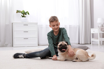 Wall Mural - Boy with his cute pug on floor at home