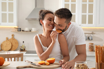 Lovely couple enjoying time together during breakfast at table in kitchen