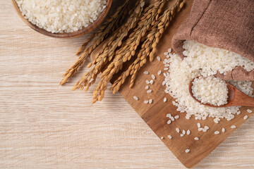 Wall Mural - White rice in a bowl on wooden table background.