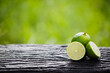 Green lemon sliced on wood
