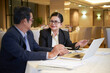 © DragonImages - Positive senior business people having meeting at restaurant table, they are discussing cooperative project an dplanning work