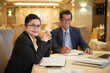 © DragonImages - Positive senior businesswoman meeting with colleague at restaurant table to discuss important issues and plan work
