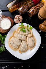 Poster - Top view fresh hot dumplings on plate. Chinese dish on rustic old vintage wooden background.