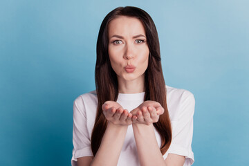 Portrait of lovely lady air kissing you isolated over blue background