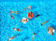 © artiemedvedev - Aerial of friends having party in swimming pool with inflatable flamingo, swan, mattress. Happy young people relax at luxury resort on sunny day. View from above. Girls in bikini sunbathing in a sun.