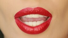 4K Closeup Of A Beautiful Woman Lips With Beautiful Red Make Up Sending Air Kiss . Close Up Of Girl's Mouth Having Flirty Emotions And Sending Air Kiss .