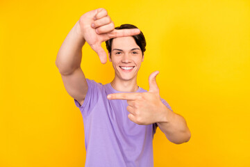 Wall Mural - Photo of positive photographer guy fingers make frame wear purple t-shirt isolated yellow color background